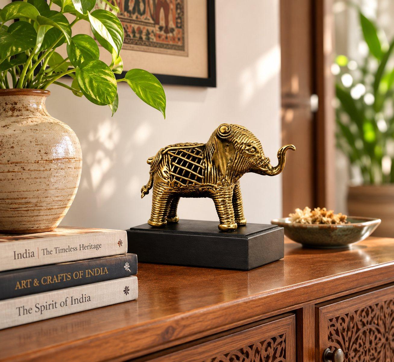 A brass Dhokra elephant with base styled on a luxury entry console