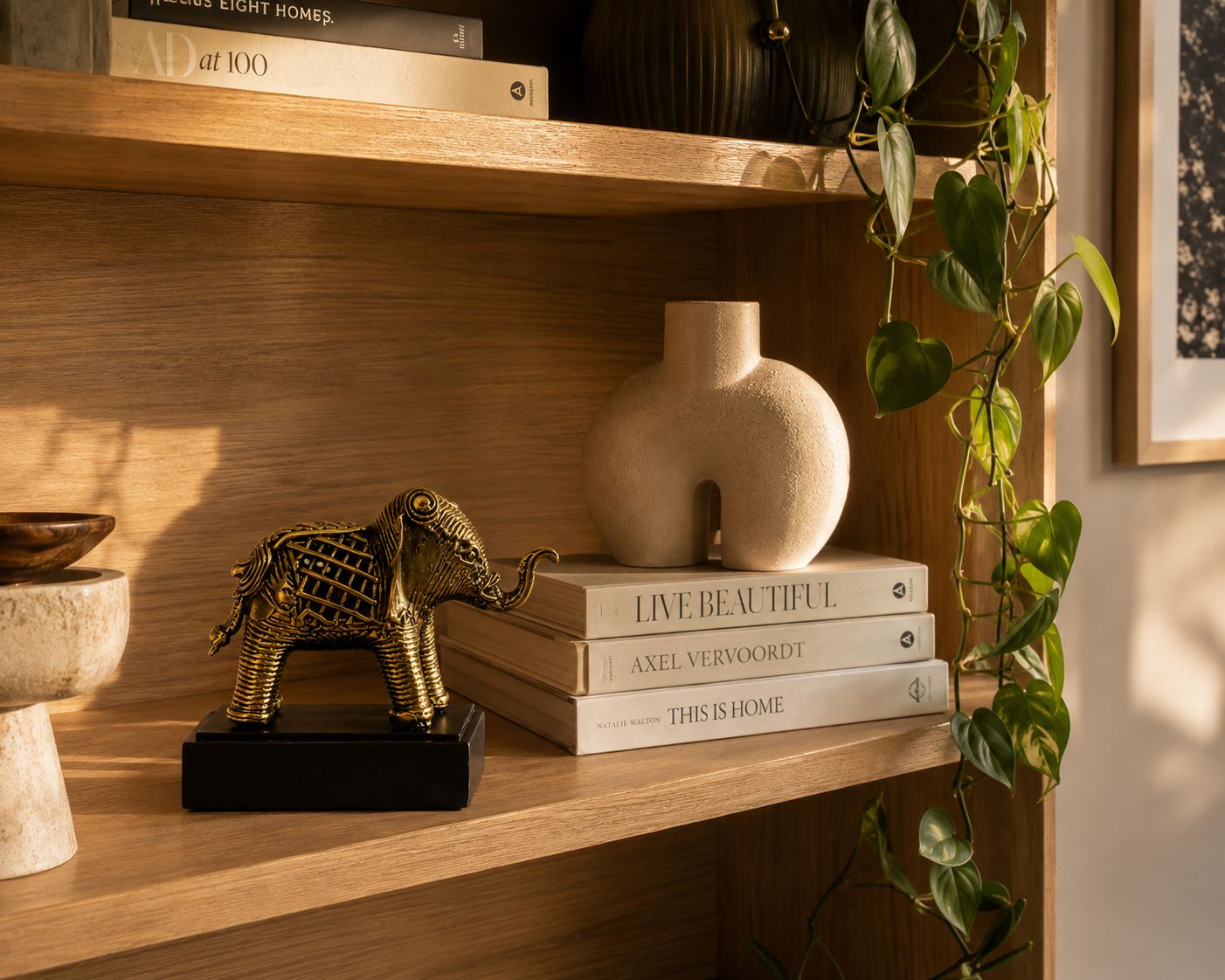 Dhokra brass elephant with base styled on a bookshelf